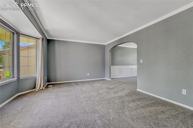 9524 Pinebrook Way, Colorado Springs, CO 80920 - empty room with ornamental molding, arched walkways, a textured ceiling, carpet, and baseboards