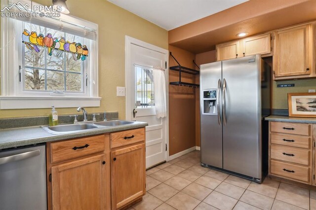 1003 N Institute St, Colorado Springs, CO 80903 - kitchen featuring appliances with stainless steel finishes, a sink, and light tile patterned flooring