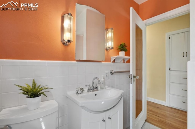 1003 N Institute St, Colorado Springs, CO 80903 - bathroom featuring toilet, vanity, tile walls, and wood finished floors