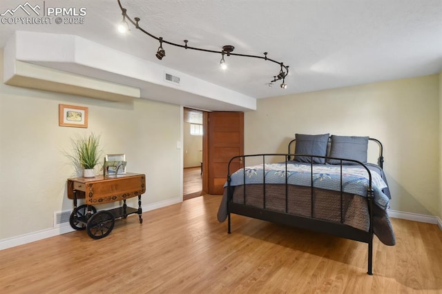 1003 N Institute St, Colorado Springs, CO 80903 - bedroom with light wood finished floors, baseboards, and track lighting