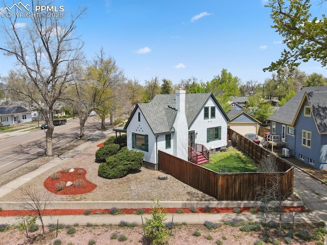 1003 N Institute St, Colorado Springs, CO 80903 - view of front facade with a residential view, a shingled roof, and a chimney