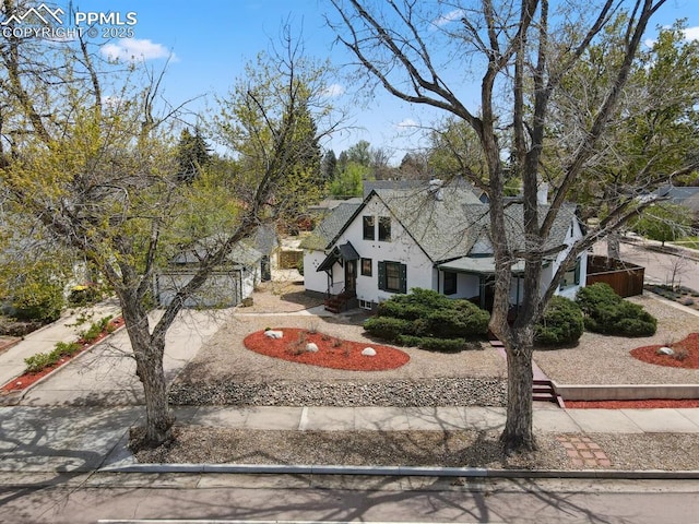 1003 N Institute St, Colorado Springs, CO 80903 - tudor-style house with driveway, a garage, and stucco siding