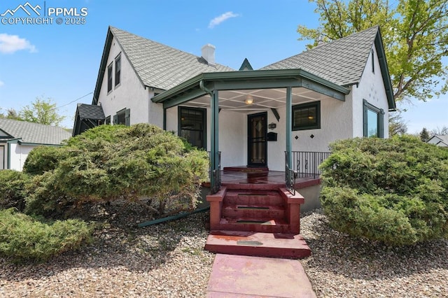 1003 N Institute St, Colorado Springs, CO 80903 - view of front of house featuring roof with shingles, stucco siding, and covered porch