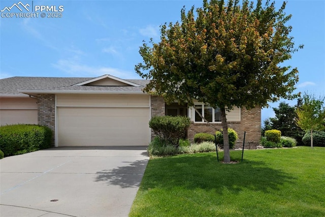 4279 Stonesthrow Vw, Colorado Springs, CO 80922 - view of front facade with brick siding, a garage, a front lawn, and driveway