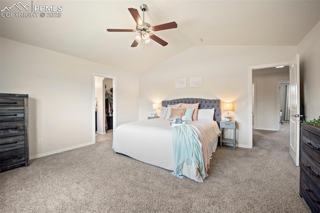 bedroom with vaulted ceiling, carpet flooring, baseboards, and a walk in closet