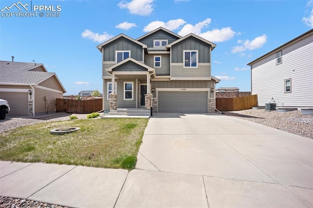 craftsman inspired home with board and batten siding, stone siding, concrete driveway, a garage, and central AC