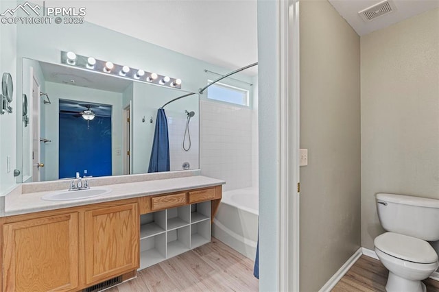 2265 Sage Grouse Ln, Colorado Springs, CO 80951 - bathroom featuring wood finished floors, toilet, vanity, shower / tub combination, and a ceiling fan