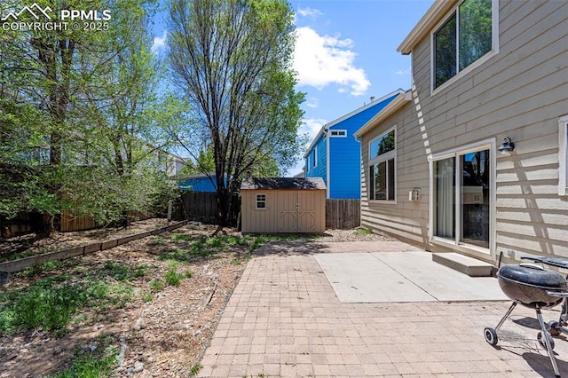 2265 Sage Grouse Ln, Colorado Springs, CO 80951 - view of patio / terrace featuring a storage unit, a fenced backyard, an outdoor structure, and a grill