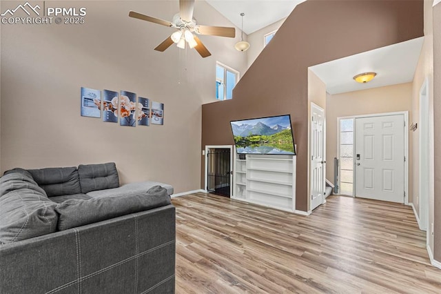 2265 Sage Grouse Ln, Colorado Springs, CO 80951 - living room featuring high vaulted ceiling, light wood-type flooring, baseboards, and a ceiling fan