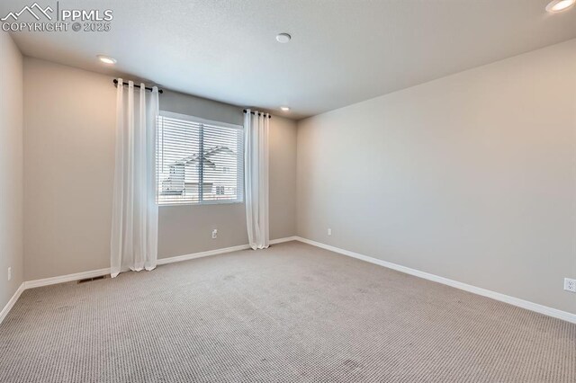 10737 Rolling Mesa Dr, Falcon, CO 80831 - carpeted spare room with baseboards and recessed lighting