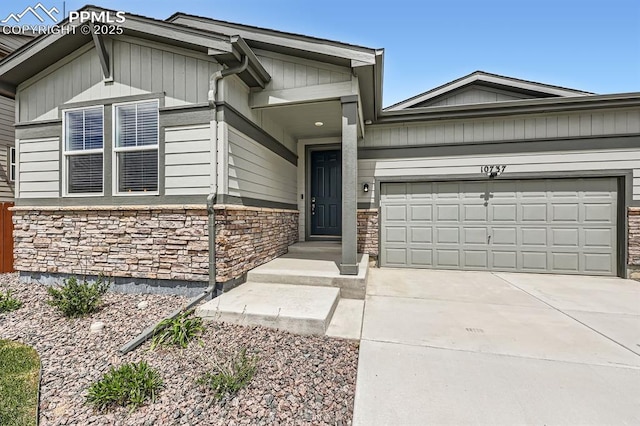 10737 Rolling Mesa Dr, Falcon, CO 80831 - view of front of house with stone siding, a garage, and driveway