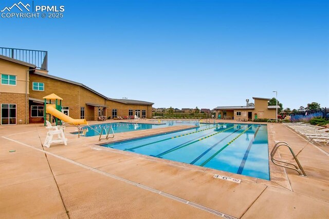 10737 Rolling Mesa Dr, Falcon, CO 80831 - community pool with a water slide and a patio
