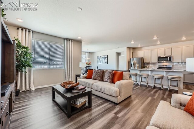 10737 Rolling Mesa Dr, Falcon, CO 80831 - living area featuring dark wood finished floors, recessed lighting, baseboards, and a chandelier
