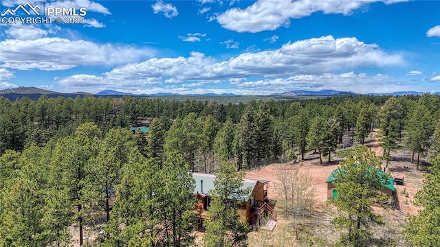 bird's eye view of a heavily wooded area and mountains