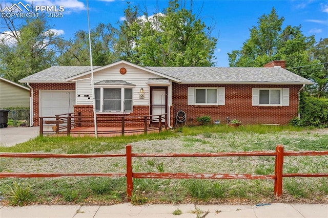 138 Hayes Dr, Colorado Springs, CO 80911 - view of front facade featuring brick siding, a fenced front yard, a garage, a chimney, and a shingled roof
