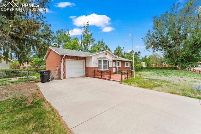 138 Hayes Dr, Colorado Springs, CO 80911 - single story home featuring brick siding, an attached garage, driveway, and a deck