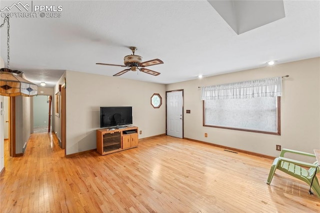 138 Hayes Dr, Colorado Springs, CO 80911 - unfurnished living room with light wood-type flooring, a ceiling fan, and baseboards