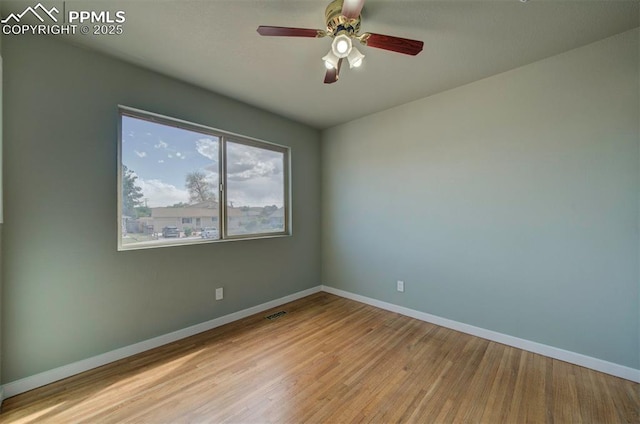 98 Security Cir, Colorado Springs, CO 80911 - unfurnished room featuring baseboards, wood finished floors, and a ceiling fan