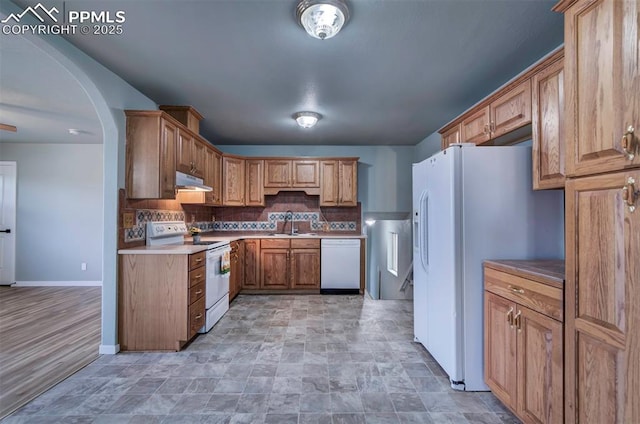 98 Security Cir, Colorado Springs, CO 80911 - kitchen featuring white appliances, under cabinet range hood, decorative backsplash, baseboards, and a sink