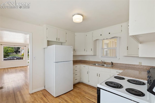 207 N 20th St, Colorado Springs, CO 80904 - kitchen with white appliances, a sink, light wood finished floors, and white cabinetry