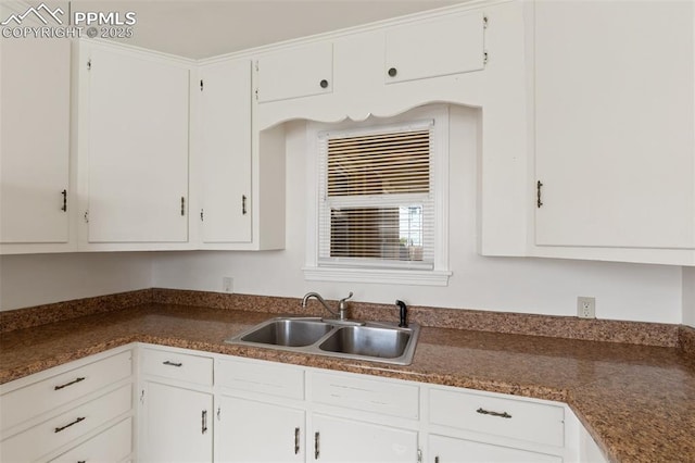207 N 20th St, Colorado Springs, CO 80904 - kitchen with a sink, dark countertops, and white cabinetry