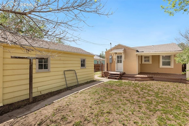207 N 20th St, Colorado Springs, CO 80904 - back of property featuring a wooden deck and a shingled roof