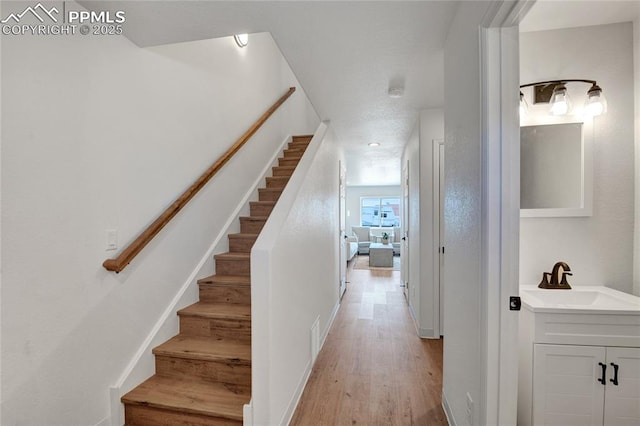 staircase with wood finished floors