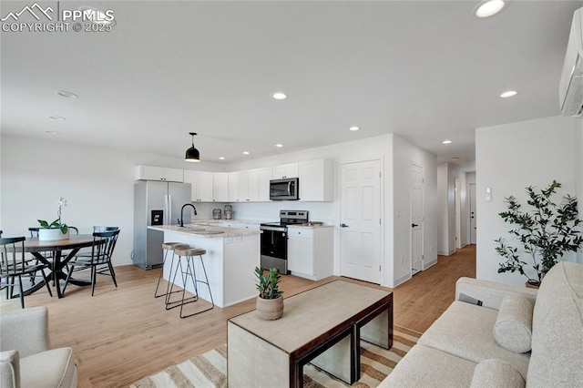 living area featuring recessed lighting and light wood finished floors