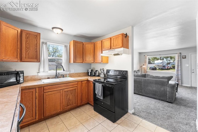 2744 Ron Ct, Colorado Springs, CO 80909 - kitchen featuring black appliances, a sink, under cabinet range hood, and plenty of natural light
