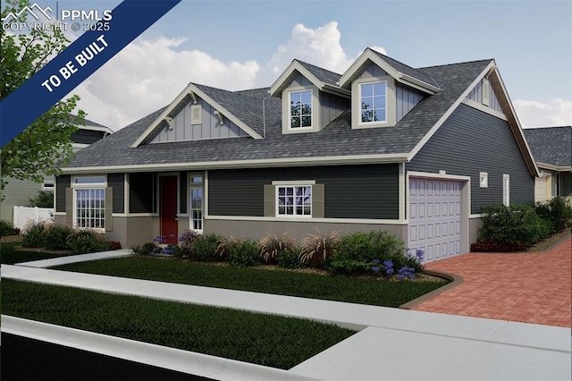 5831 Mireland Vw, Colorado Springs, CO 80927 - view of front facade featuring decorative driveway, board and batten siding, an attached garage, and a shingled roof
