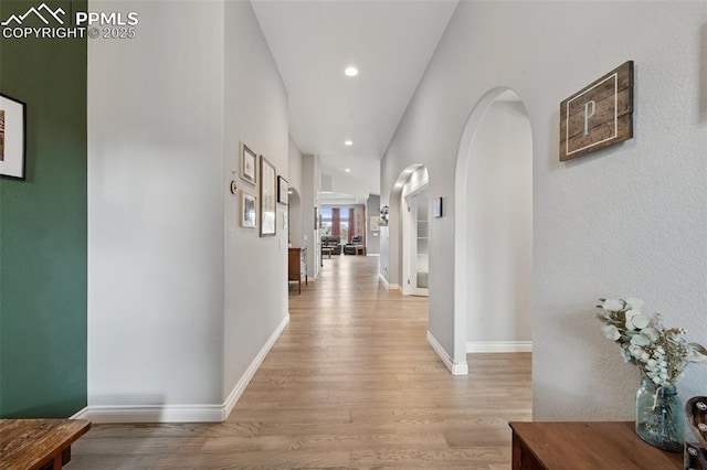 6949 Compass Bend Dr, Colorado Springs, CO 80927 - corridor featuring light wood-style flooring, arched walkways, baseboards, and recessed lighting