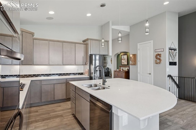 6949 Compass Bend Dr, Colorado Springs, CO 80927 - kitchen with a sink, appliances with stainless steel finishes, light wood-style floors, light countertops, and pendant lighting