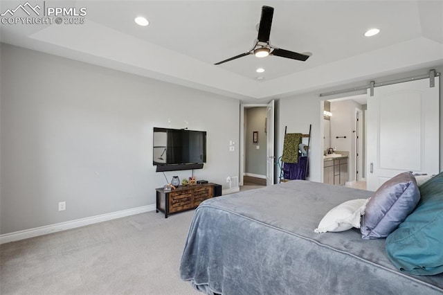 6949 Compass Bend Dr, Colorado Springs, CO 80927 - bedroom featuring a raised ceiling, recessed lighting, baseboards, a barn door, and light colored carpet