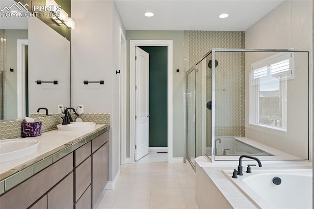 6949 Compass Bend Dr, Colorado Springs, CO 80927 - bathroom with a garden tub, a shower stall, double vanity, tile patterned floors, and baseboards