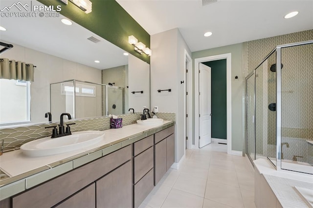 6949 Compass Bend Dr, Colorado Springs, CO 80927 - full bathroom with a stall shower, a garden tub, double vanity, tile patterned floors, and recessed lighting