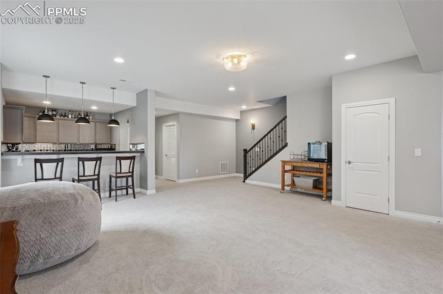 6949 Compass Bend Dr, Colorado Springs, CO 80927 - living room with light carpet, stairs, recessed lighting, and baseboards