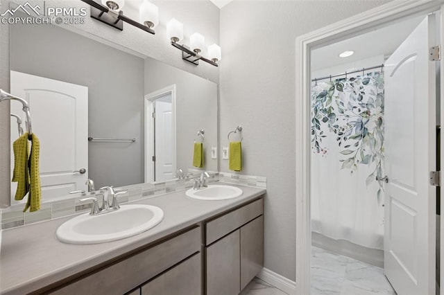 6949 Compass Bend Dr, Colorado Springs, CO 80927 - full bathroom with marble look tile flooring, double vanity, and a shower with shower curtain