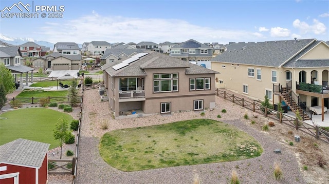 6949 Compass Bend Dr, Colorado Springs, CO 80927 - back of house featuring a fenced backyard, a residential view, stucco siding, and a gate