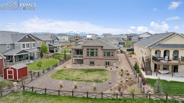 6949 Compass Bend Dr, Colorado Springs, CO 80927 - back of property featuring a residential view, a fenced backyard, stucco siding, and stairway
