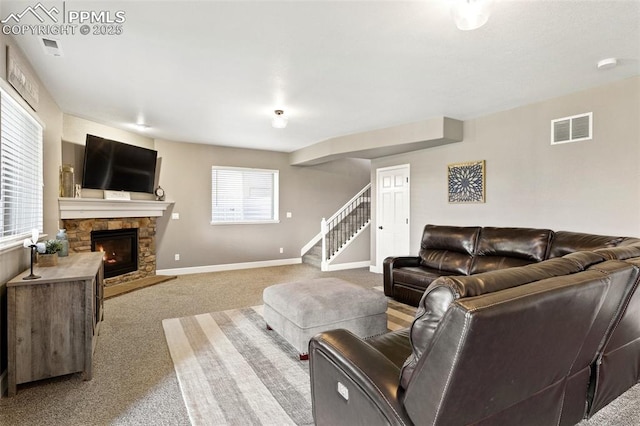 444 Pasada Way, Monument, CO 80132 - living room with stairway, carpet flooring, a fireplace, and baseboards