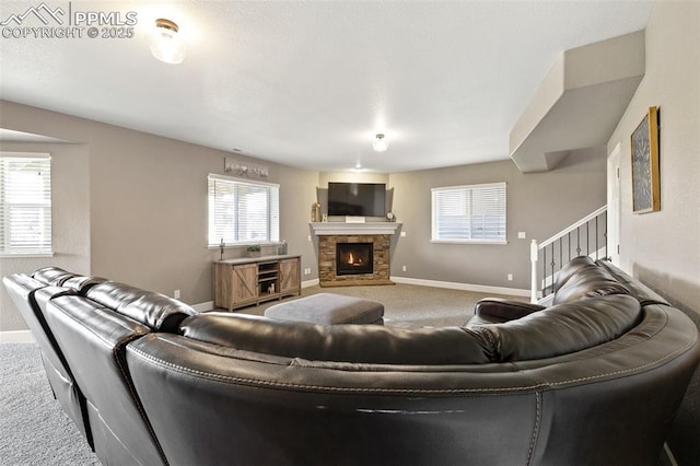 444 Pasada Way, Monument, CO 80132 - carpeted living room featuring healthy amount of natural light, baseboards, a fireplace, and stairs