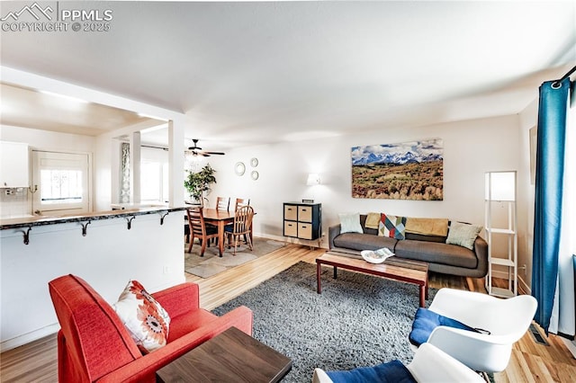 2506 Templeton Gap Rd, Colorado Springs, CO 80907 - living area featuring light wood-type flooring, ceiling fan, and baseboards