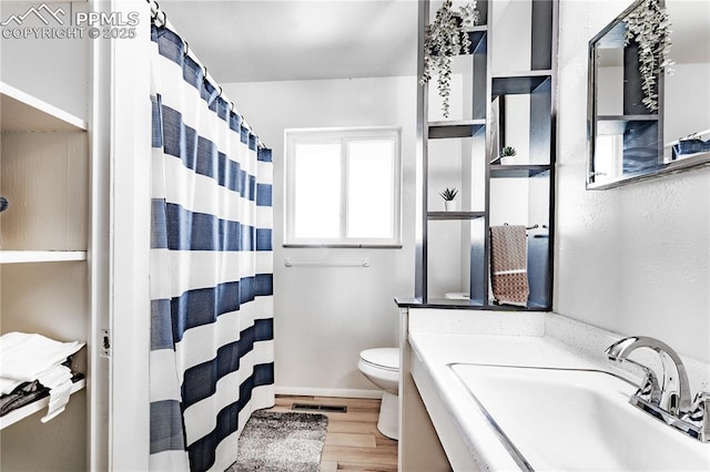2506 Templeton Gap Rd, Colorado Springs, CO 80907 - bathroom with toilet, wood finished floors, a shower with shower curtain, and vanity