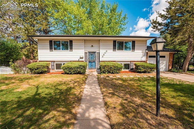 2506 Templeton Gap Rd, Colorado Springs, CO 80907 - split foyer home featuring brick siding, driveway, and an attached garage