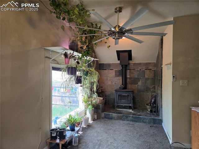 46 Sunflower Rd, Colorado Springs, CO 80907 - unfurnished living room with carpet flooring, a wood stove, and a ceiling fan