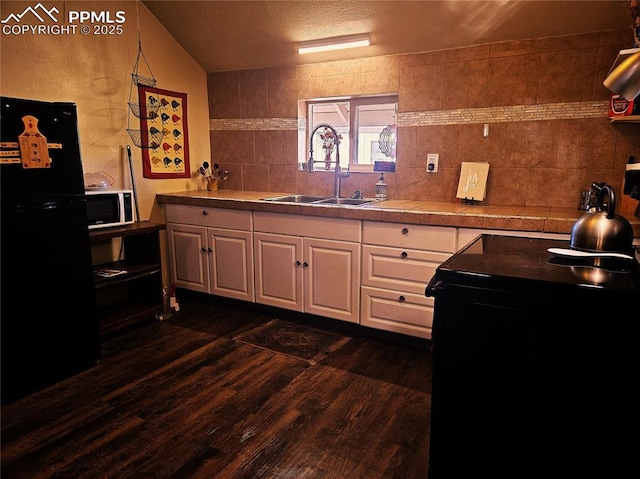 46 Sunflower Rd, Colorado Springs, CO 80907 - kitchen with a sink, black appliances, white cabinetry, dark wood finished floors, and backsplash