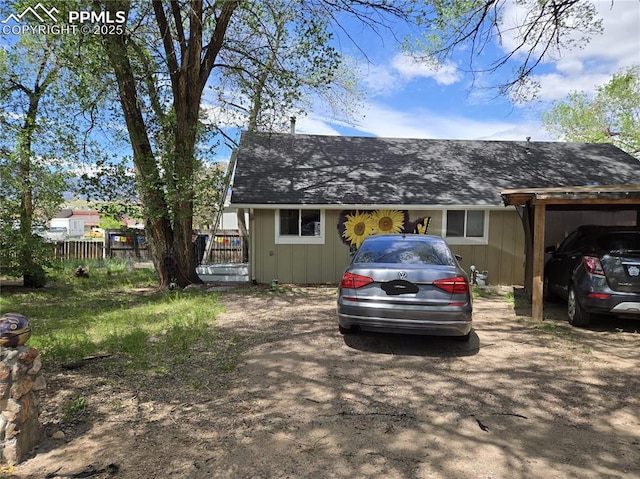 46 Sunflower Rd, Colorado Springs, CO 80907 - view of property exterior with fence, a shingled roof, and a carport