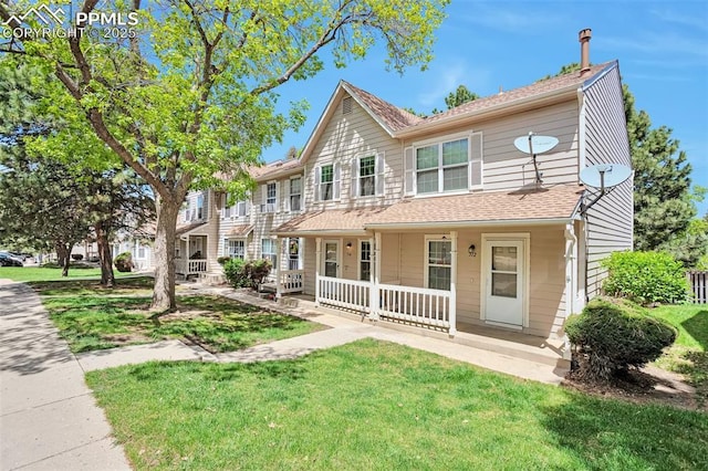 514 Shady Crest Cir, Colorado Springs, CO 80916 - townhome / multi-family property with covered porch, a front yard, and a shingled roof