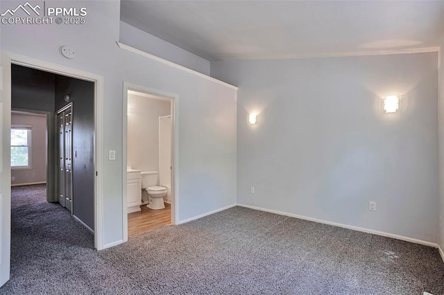 514 Shady Crest Cir, Colorado Springs, CO 80916 - unfurnished bedroom with carpet floors, baseboards, ensuite bath, and vaulted ceiling