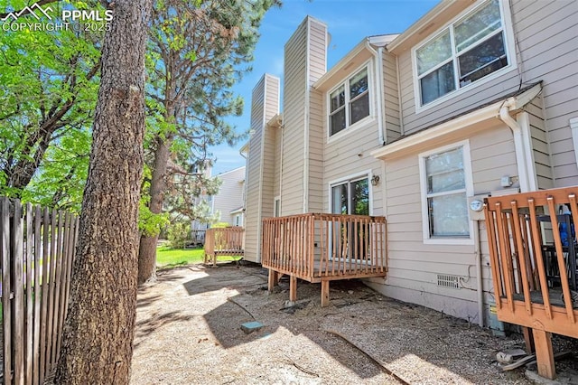 514 Shady Crest Cir, Colorado Springs, CO 80916 - rear view of property with a wooden deck and a chimney